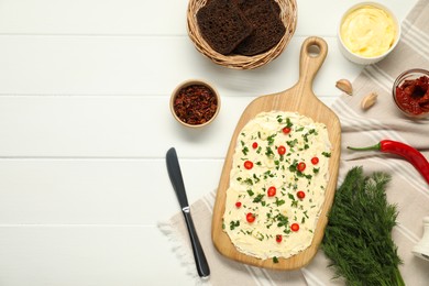 Photo of Fresh natural butter board with ingredients, bread and knife on white wooden table, flat lay. Space for text