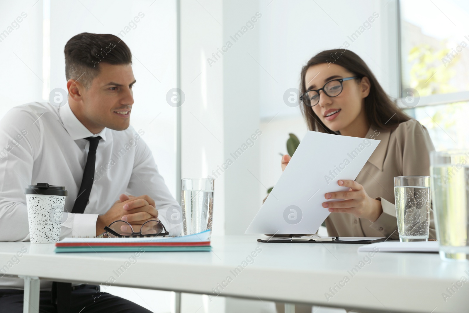 Photo of Office employees talking at table during meeting