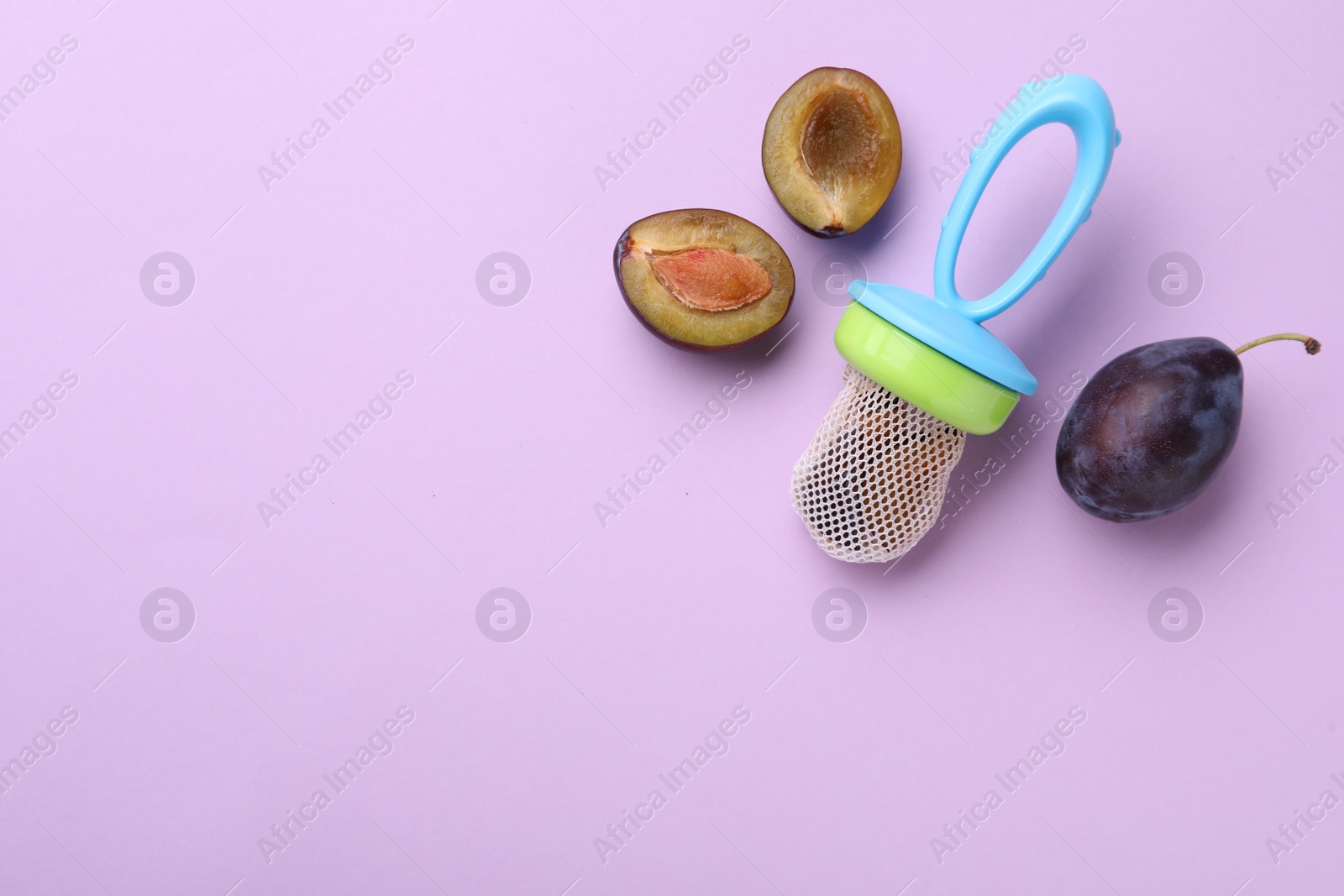 Photo of Nibbler with fresh plum on violet background, flat lay. Space for text