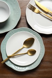 Photo of Beautiful ceramic dishware and cutlery on wooden table, flat lay