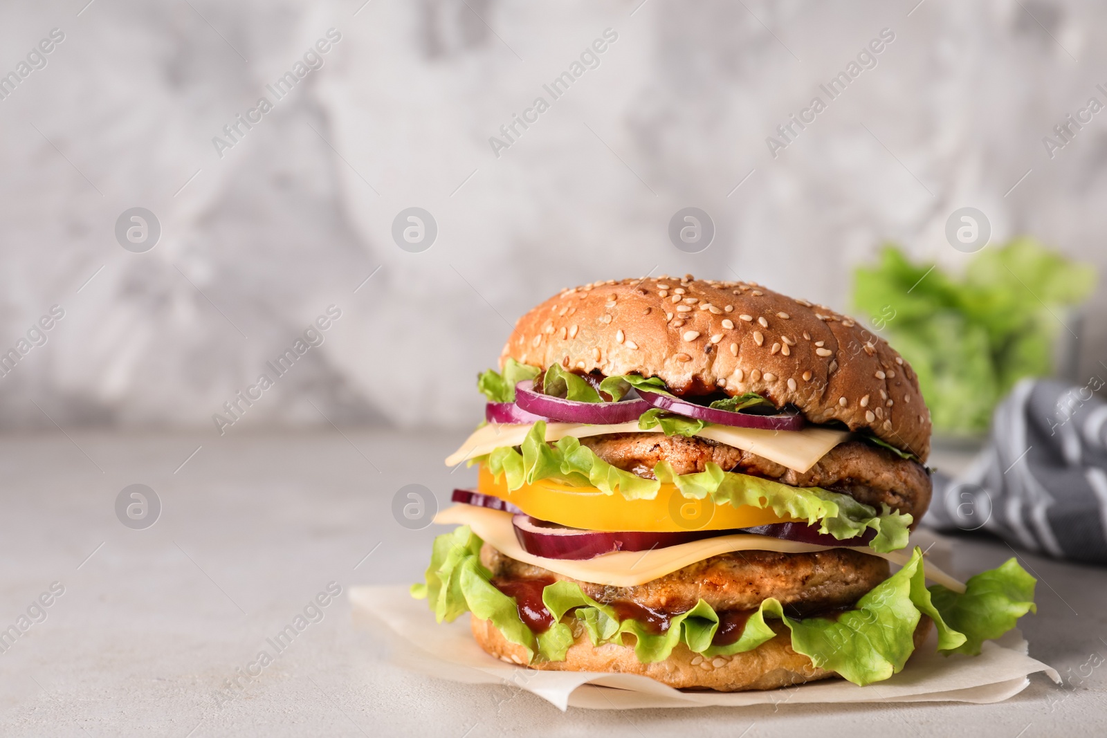 Photo of Delicious hamburger on table. Space for text