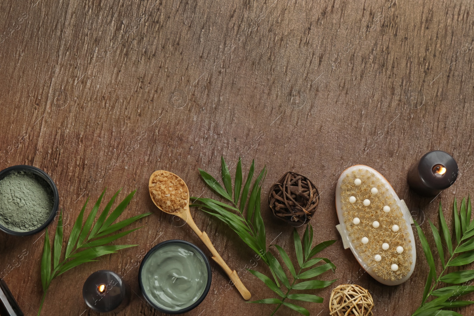 Photo of Flat lay composition with cosmetic products on wooden background, space for text. Spa body wraps