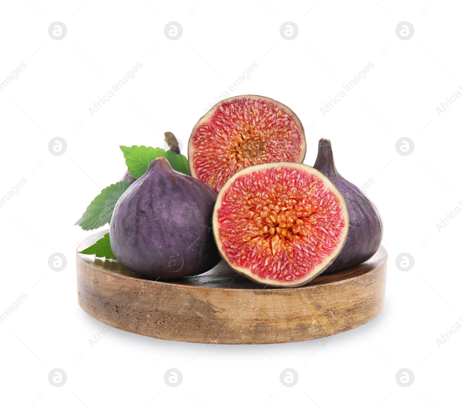 Photo of Wooden plate with whole and cut fresh purple figs isolated on white