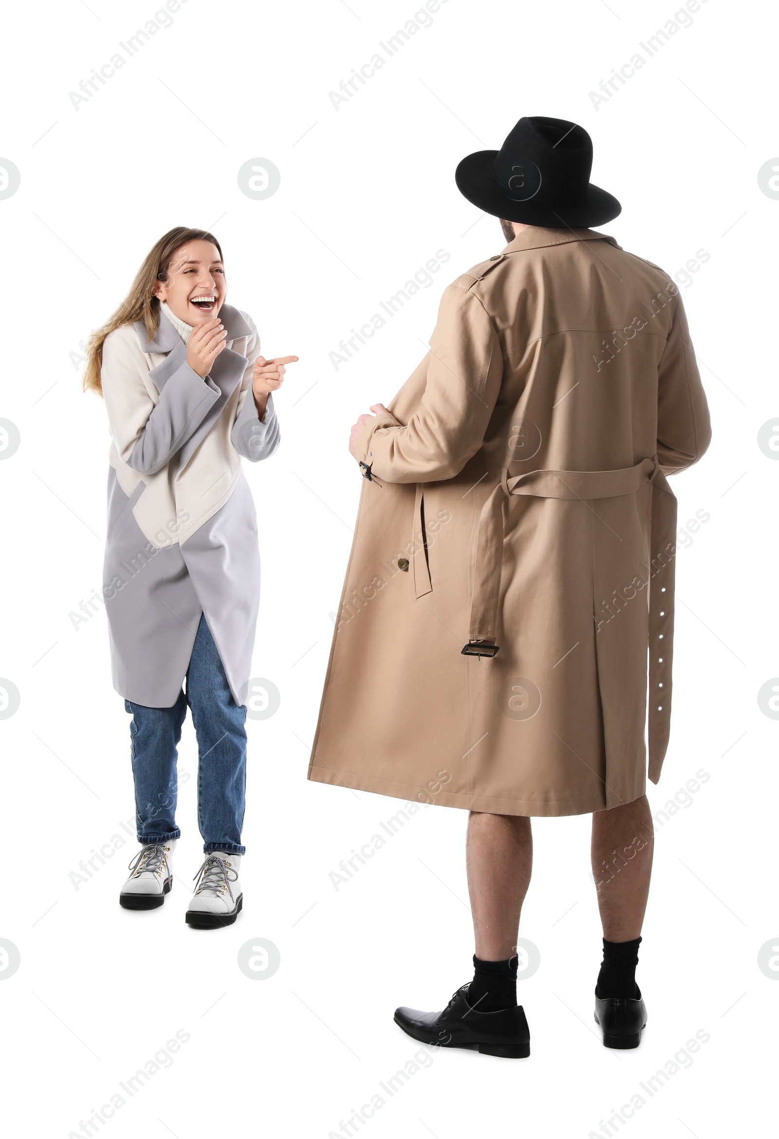 Photo of Exhibitionist exposing naked body under coat in front of young woman isolated on white