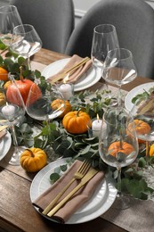 Photo of Beautiful autumn table setting. Plates, cutlery, glasses, pumpkins and floral decor