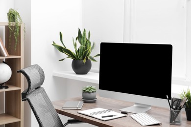 Photo of Workspace with desk, chair and computer at home