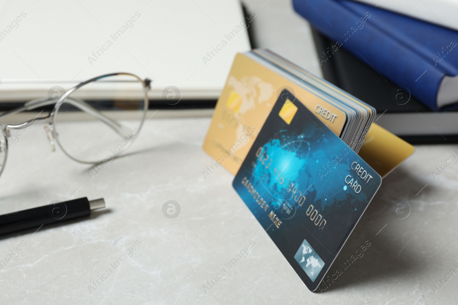 Photo of Many different credit cards on light grey marble table