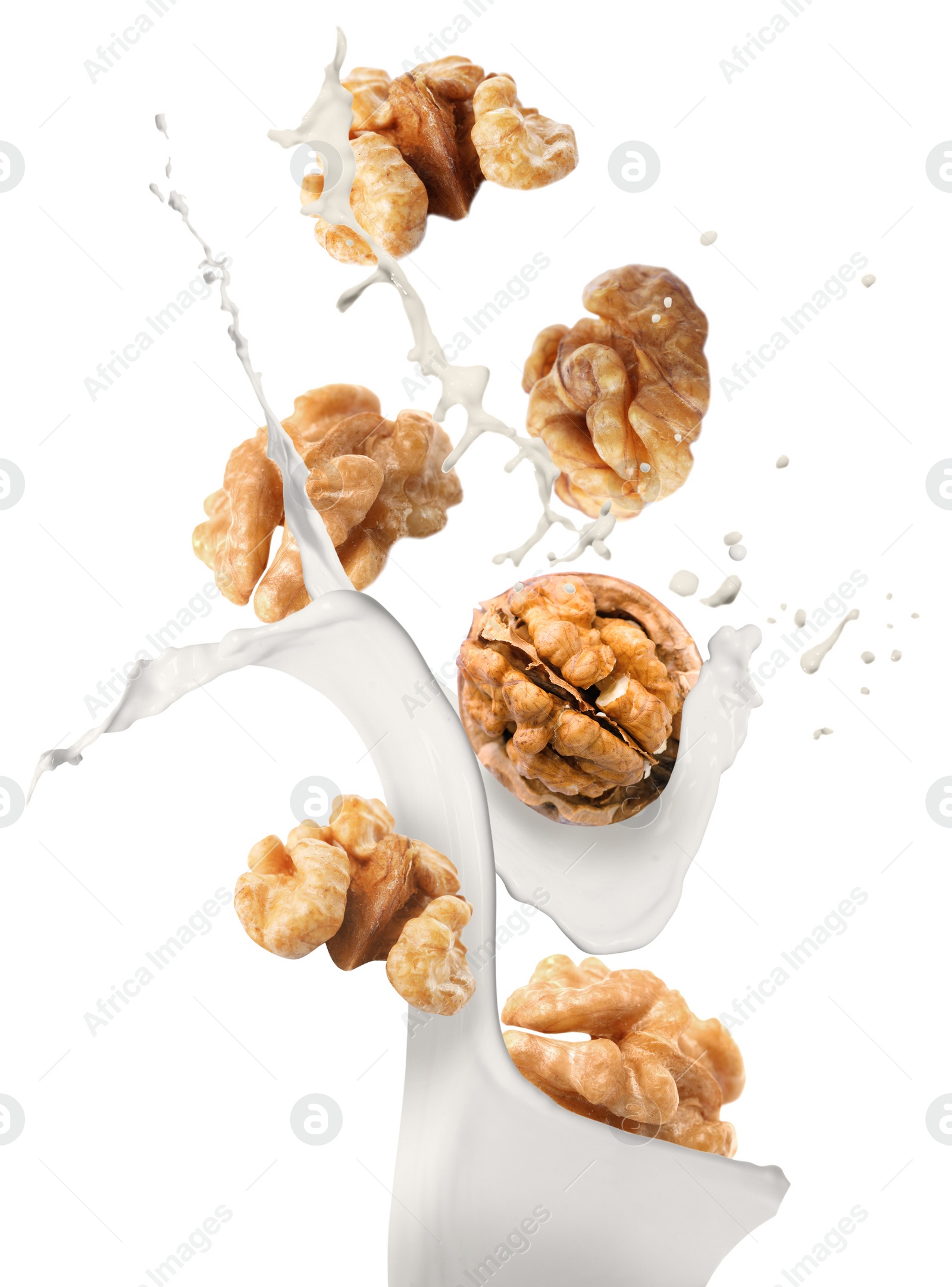 Image of Delicious walnut milk and nuts on white background