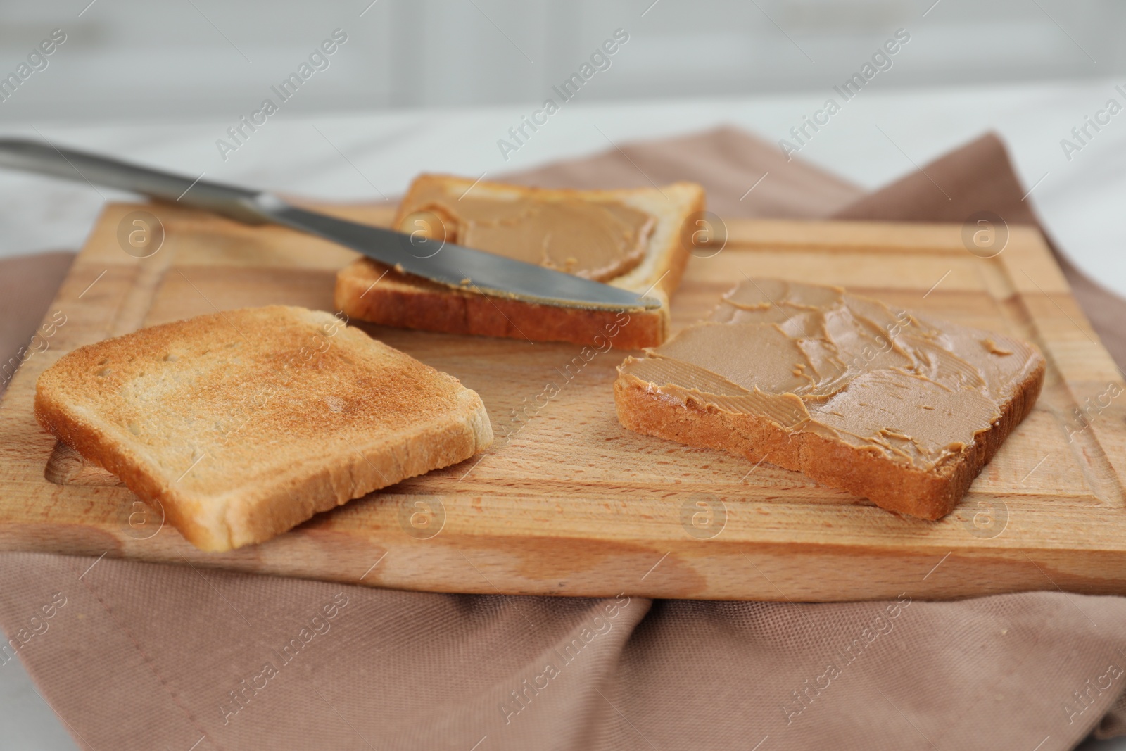 Photo of Toasts with tasty nut butter on table, closeup