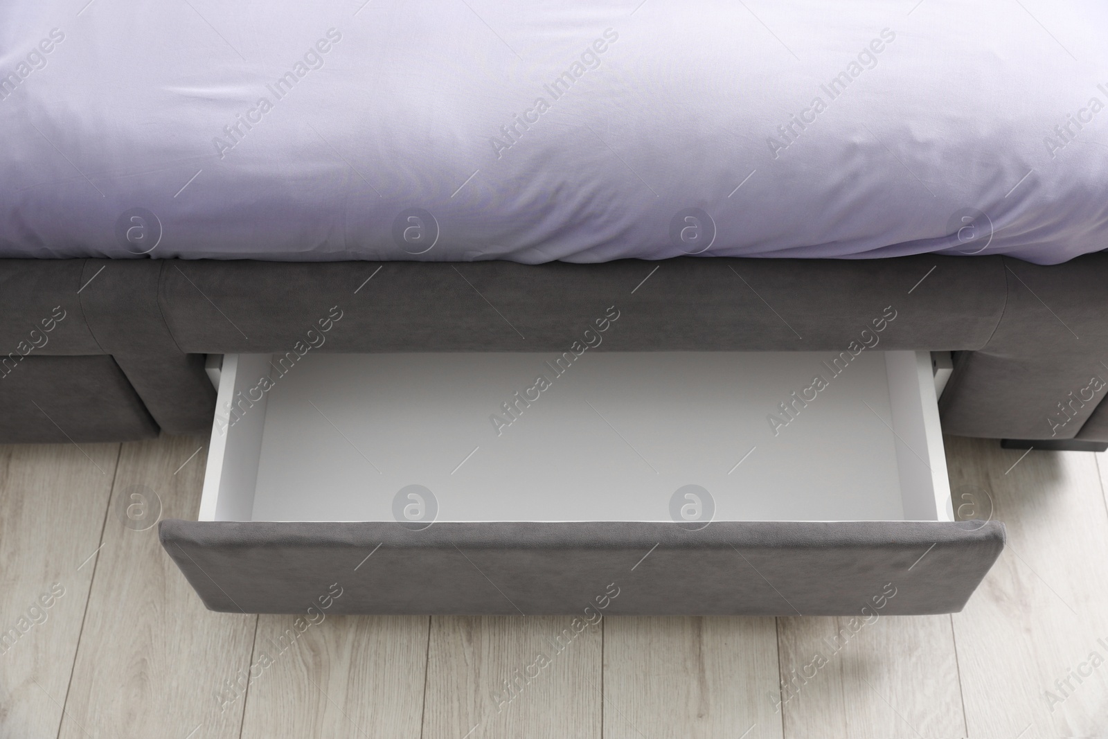 Photo of Storage drawer for bedding under modern bed in room, above view