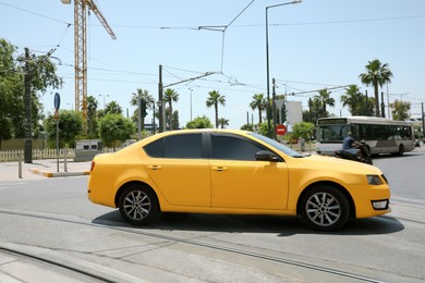 Yellow modern car on road on sunny day