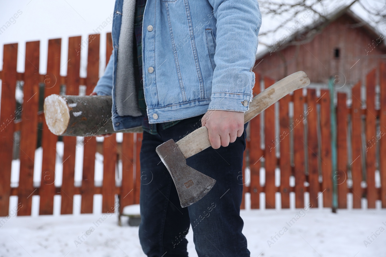 Photo of Man with axe and wood outdoors on winter day, closeup