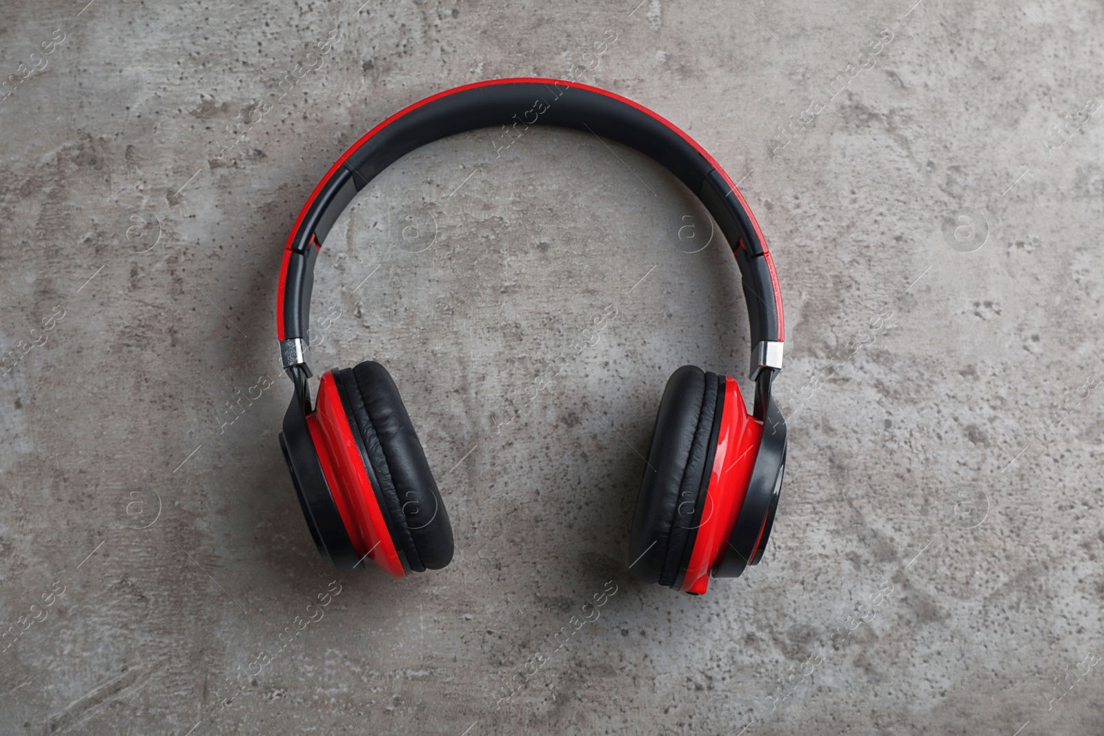 Photo of Stylish modern headphones with earmuffs on gray background, top view