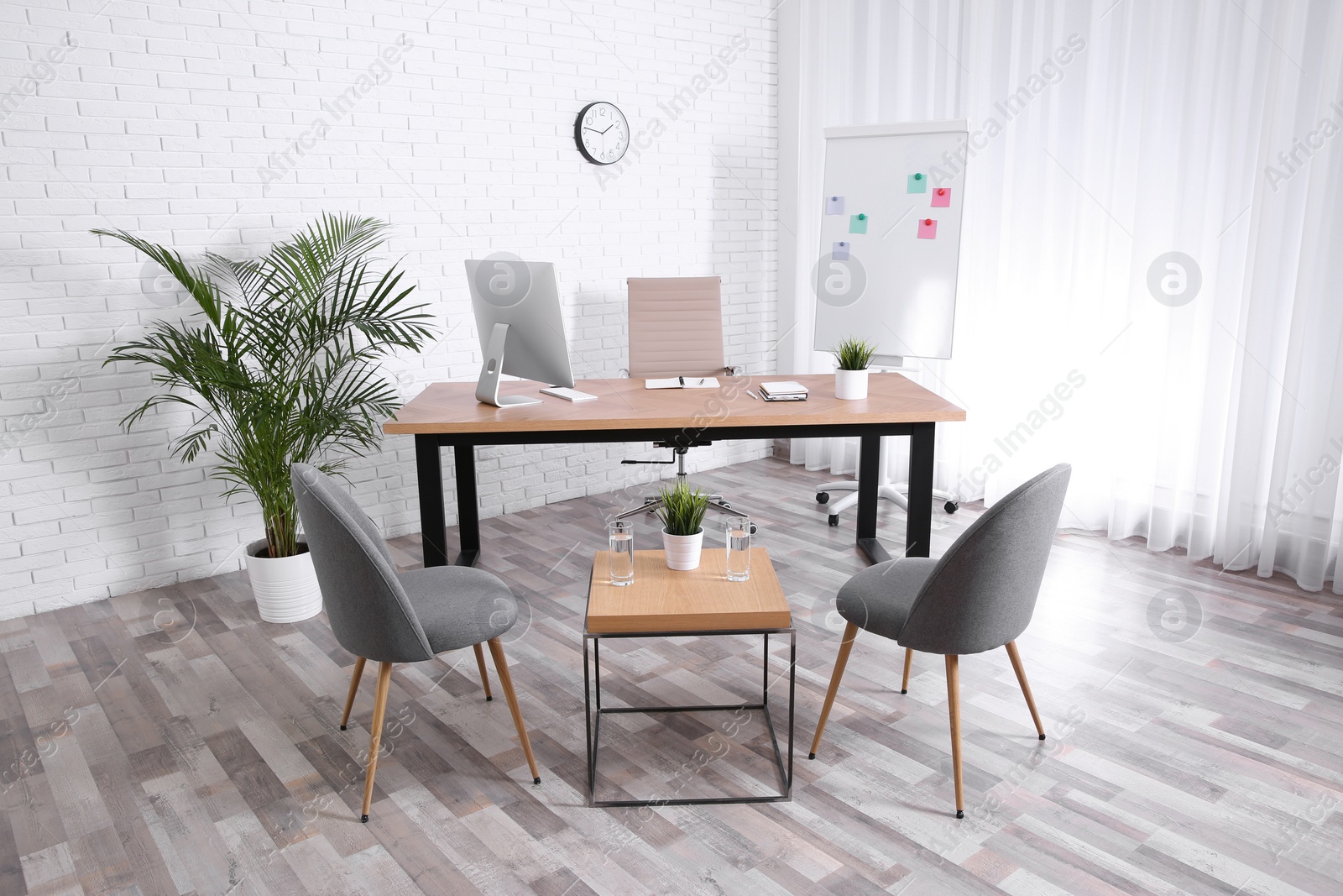 Photo of Interior of modern office with table, chairs and computer