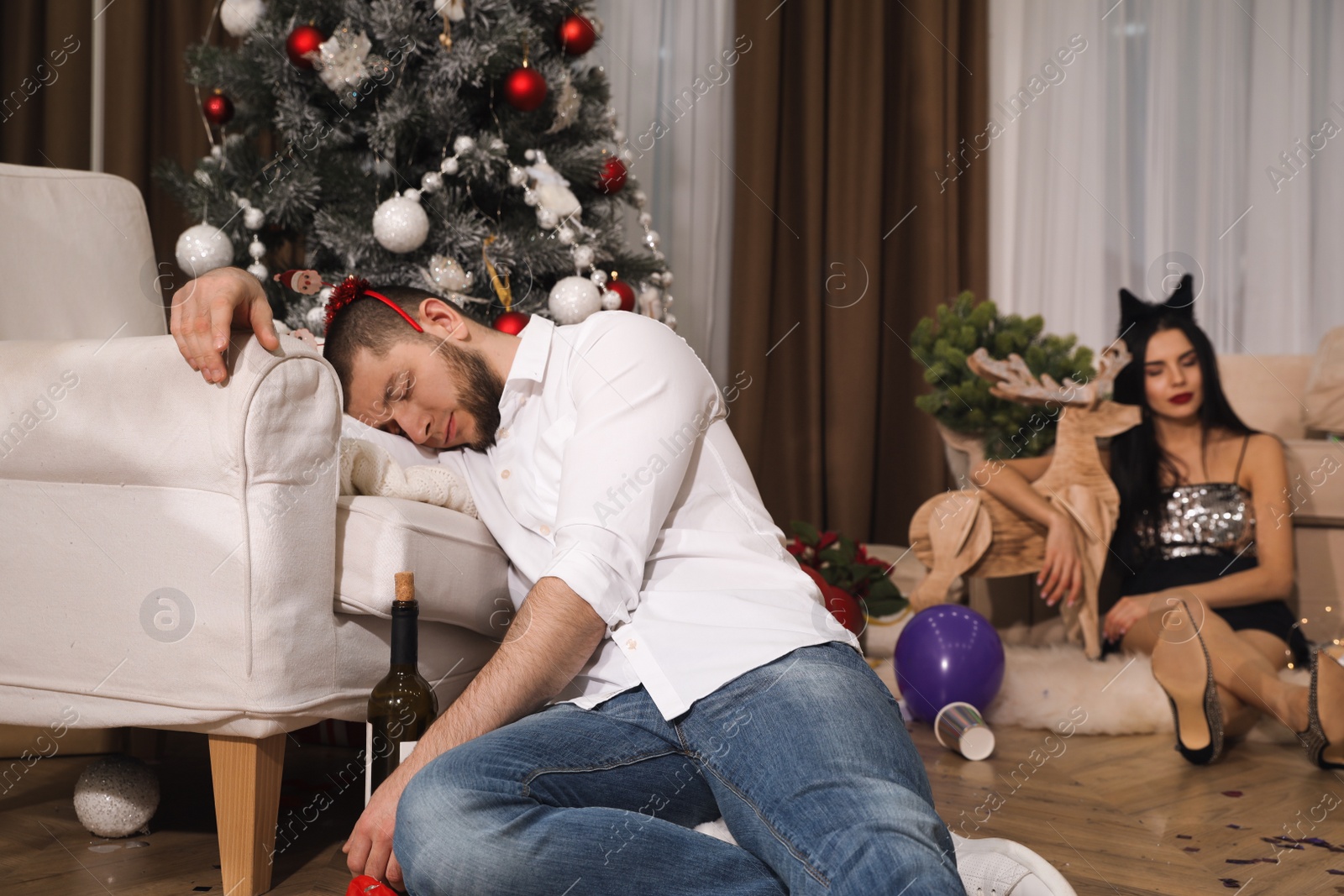 Photo of People sleeping in messy room after New Year party