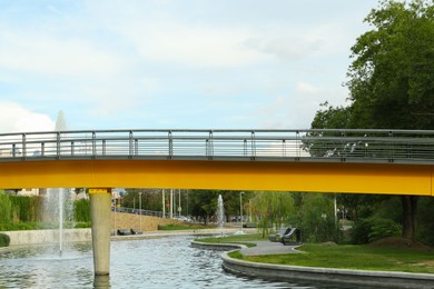 Photo of Beautiful view of bridge over pond with fontains in park