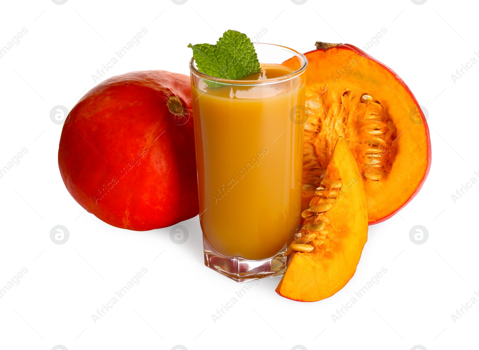 Photo of Glass of pumpkin juice and fresh vegetables with mint leaves on white background
