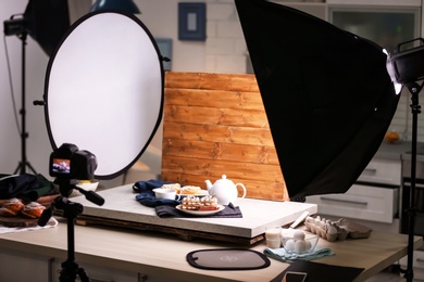 Photo of Professional camera on tripod and food composition in photo studio