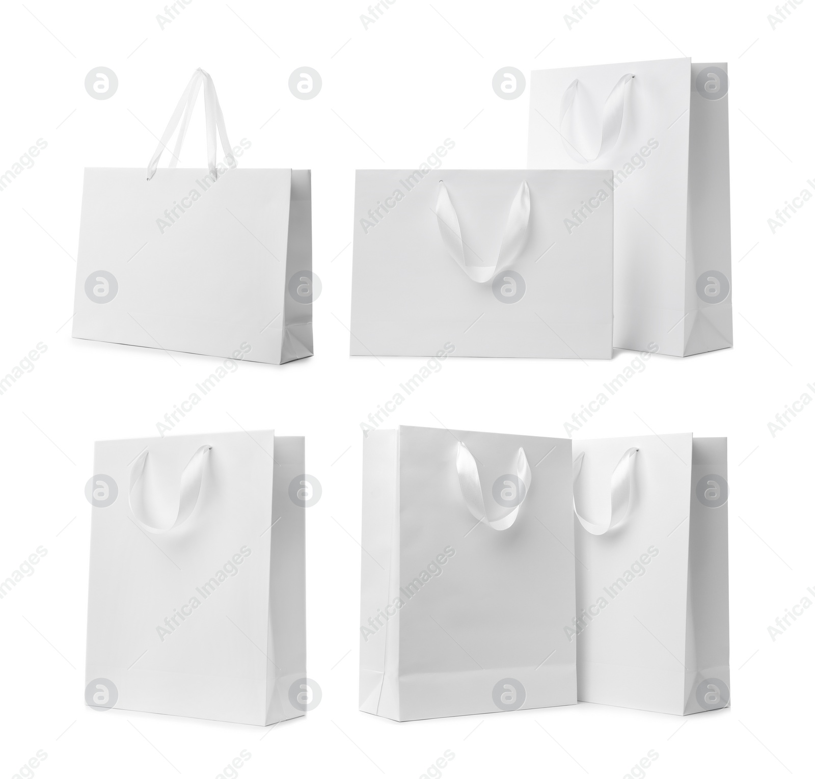 Image of Set with paper shopping bags on white background