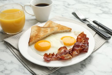 Delicious breakfast with sunny side up eggs served on white marble table, closeup