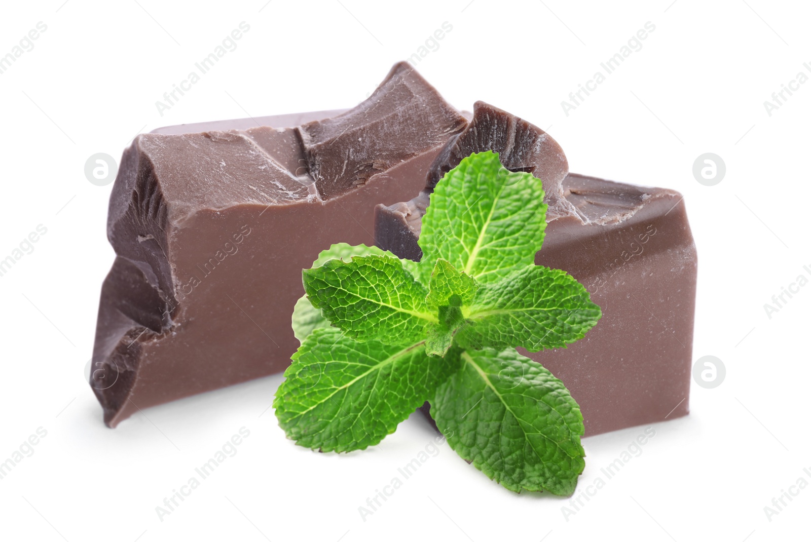 Image of Tasty milk chocolate pieces and mint on white background