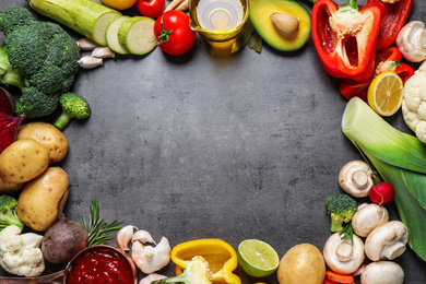 Flat lay composition with fresh products on grey table, space for text. Healthy cooking