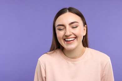 Photo of Portrait of beautiful woman laughing on violet background