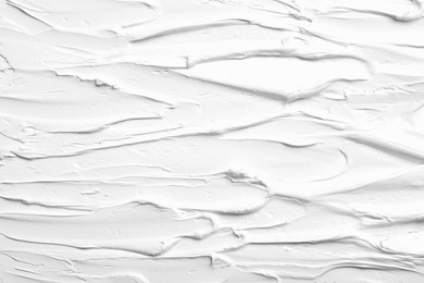 Photo of Texture of white oil paint as background, closeup