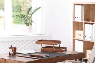 Photo of Wooden table with stationery in lawyer's office