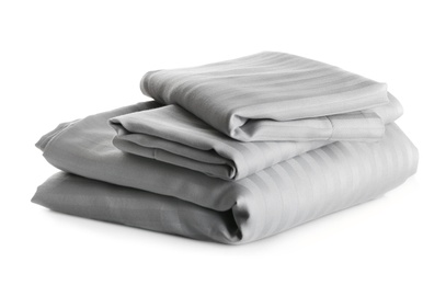 Photo of Stack of clean bed sheets isolated on white