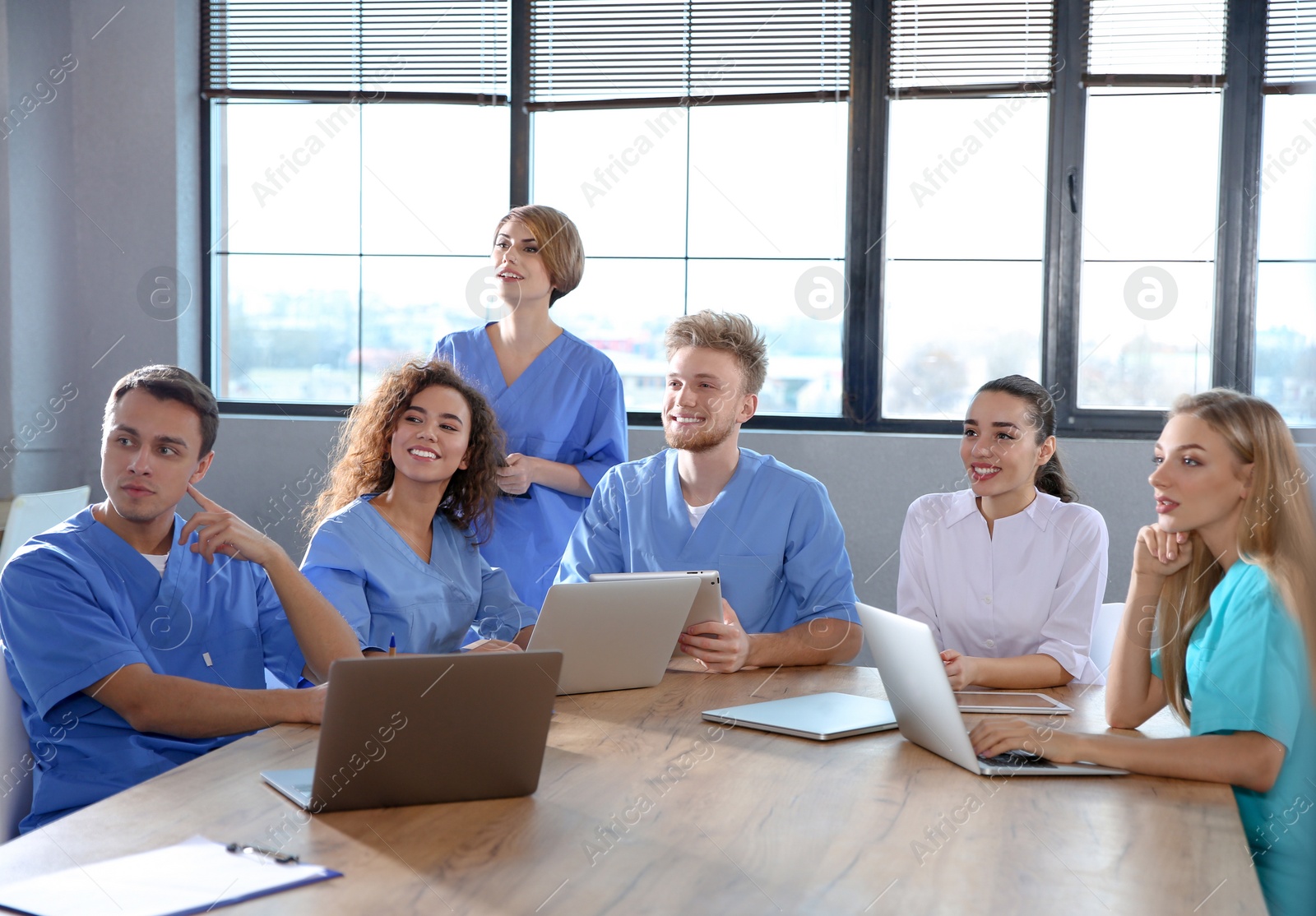 Photo of Group of smart medical students with gadgets in college