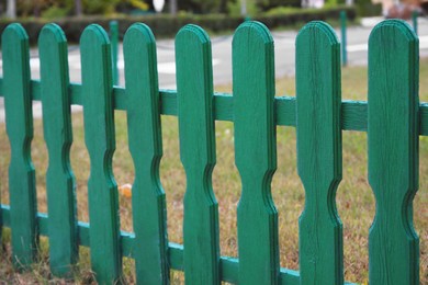 Photo of Small green wooden fence outdoors, closeup view