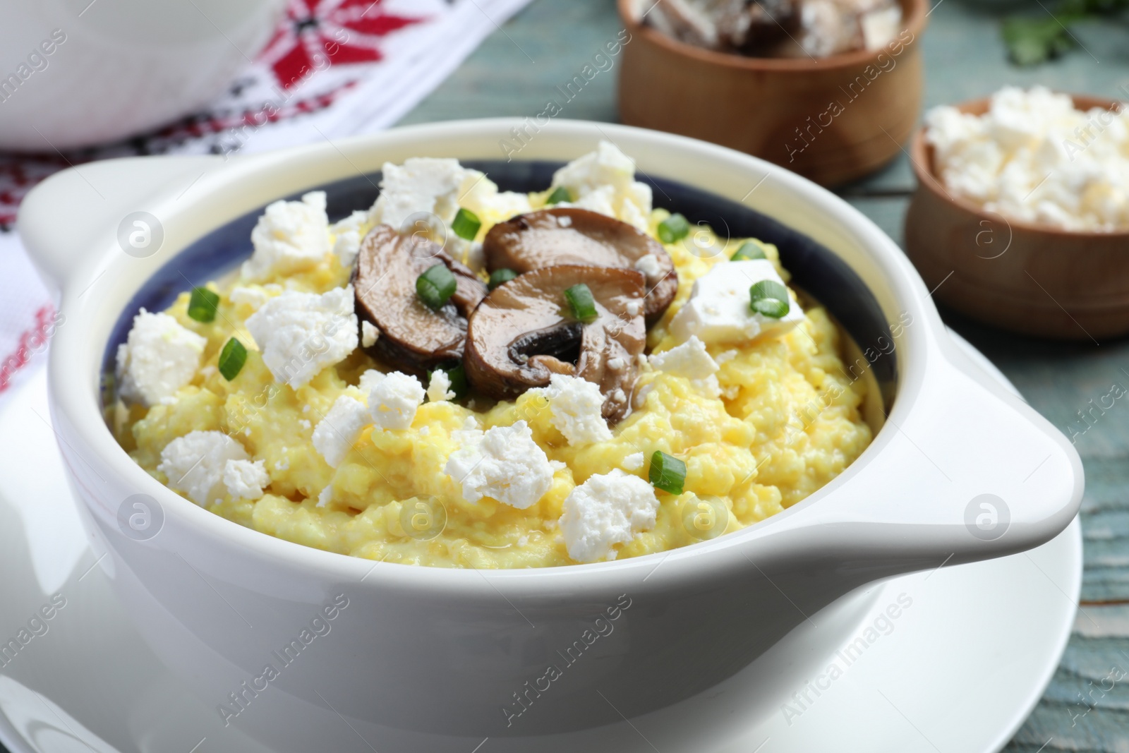 Photo of Delicious traditional banosh on blue wooden table, closeup