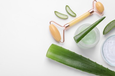 Flat lay composition with cosmetic products and cut aloe leaves on white background. Space for text