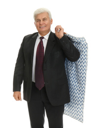 Photo of Senior man holding garment cover with clothes on white background. Dry-cleaning service