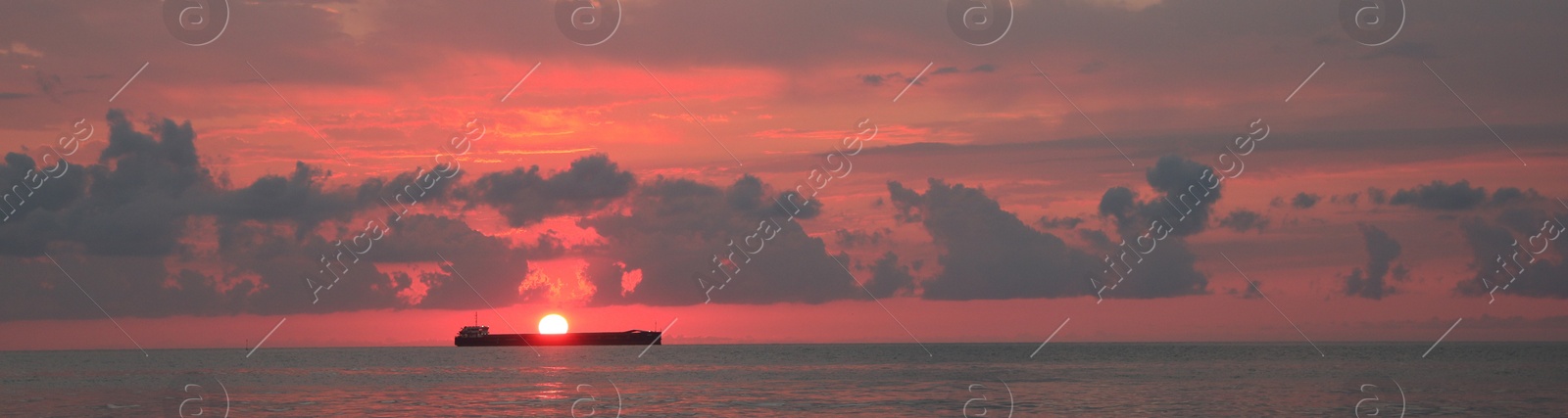 Image of Beautiful sky with sun over sea at sunset, banner design. Ship sailing at sunset
