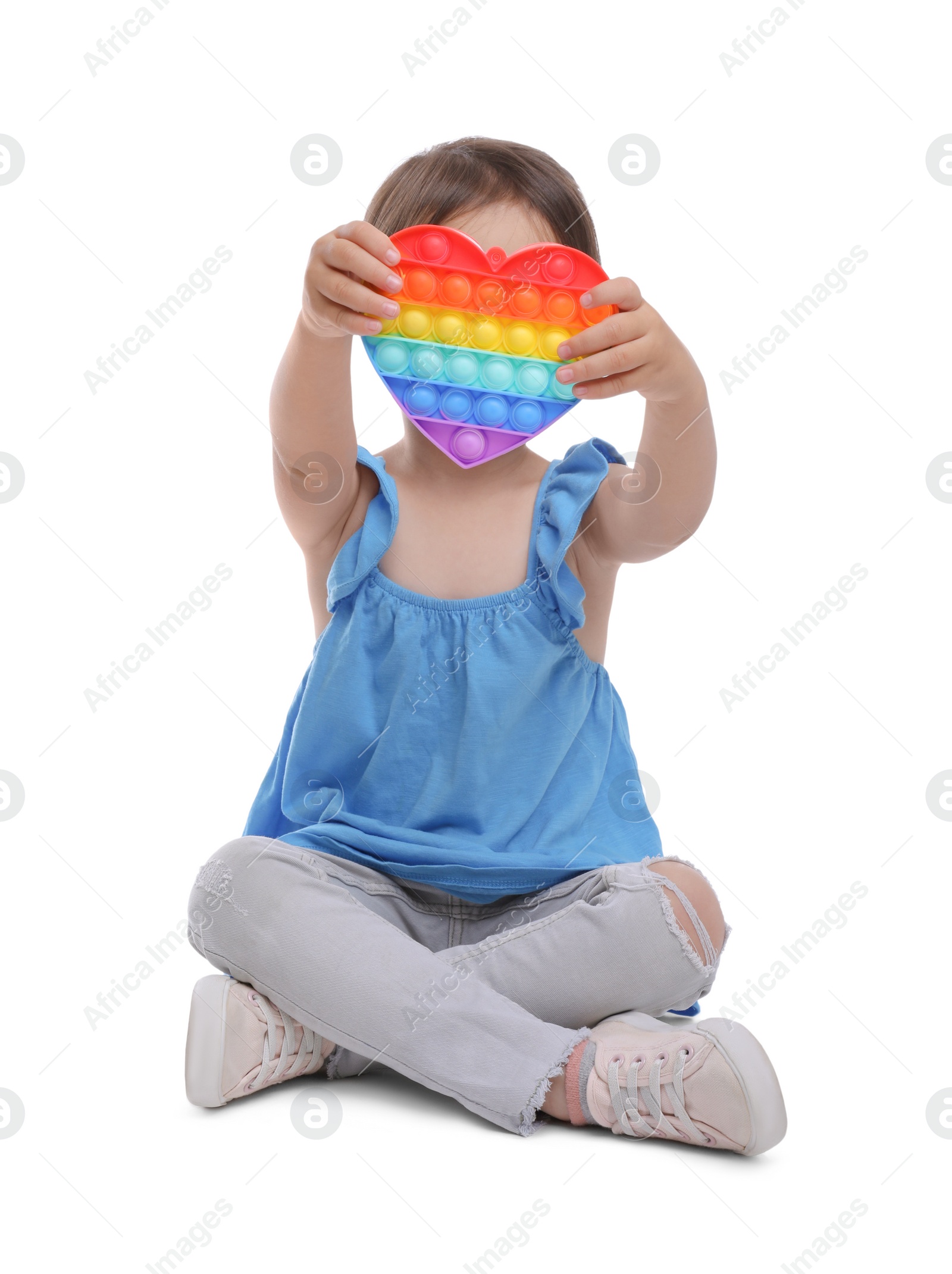 Photo of Little girl with pop it fidget toy on white background