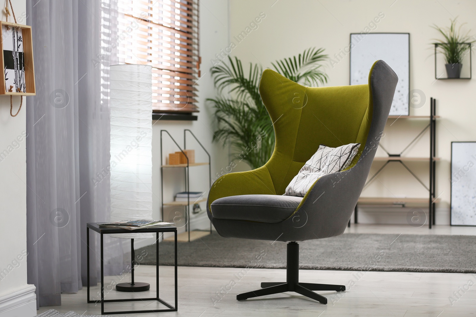 Photo of Stylish living room interior with comfortable armchair and window blinds