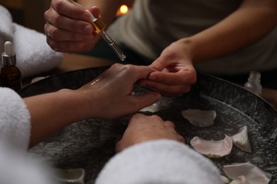 Photo of Woman receiving hand treatment in spa, closeup