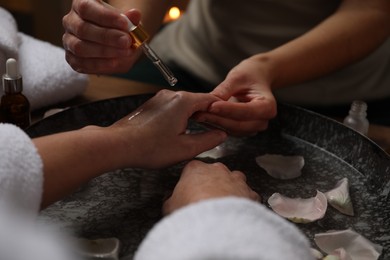 Woman receiving hand treatment in spa, closeup