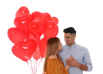 Photo of Lovely couple with heart shaped balloons on white background. Valentine's day celebration