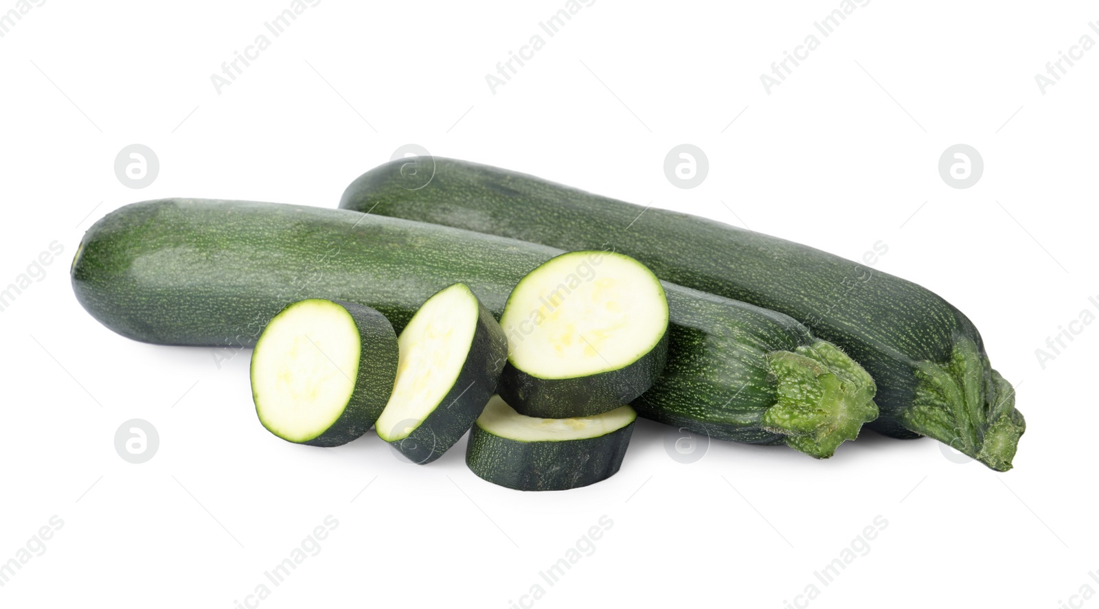 Photo of Cut and whole green ripe zucchini isolated on white