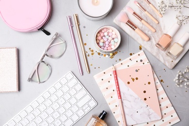 Set of accessories, cosmetics and computer keyboard on grey background, flat lay