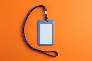 Blank badge on orange background, top view. Mockup for design