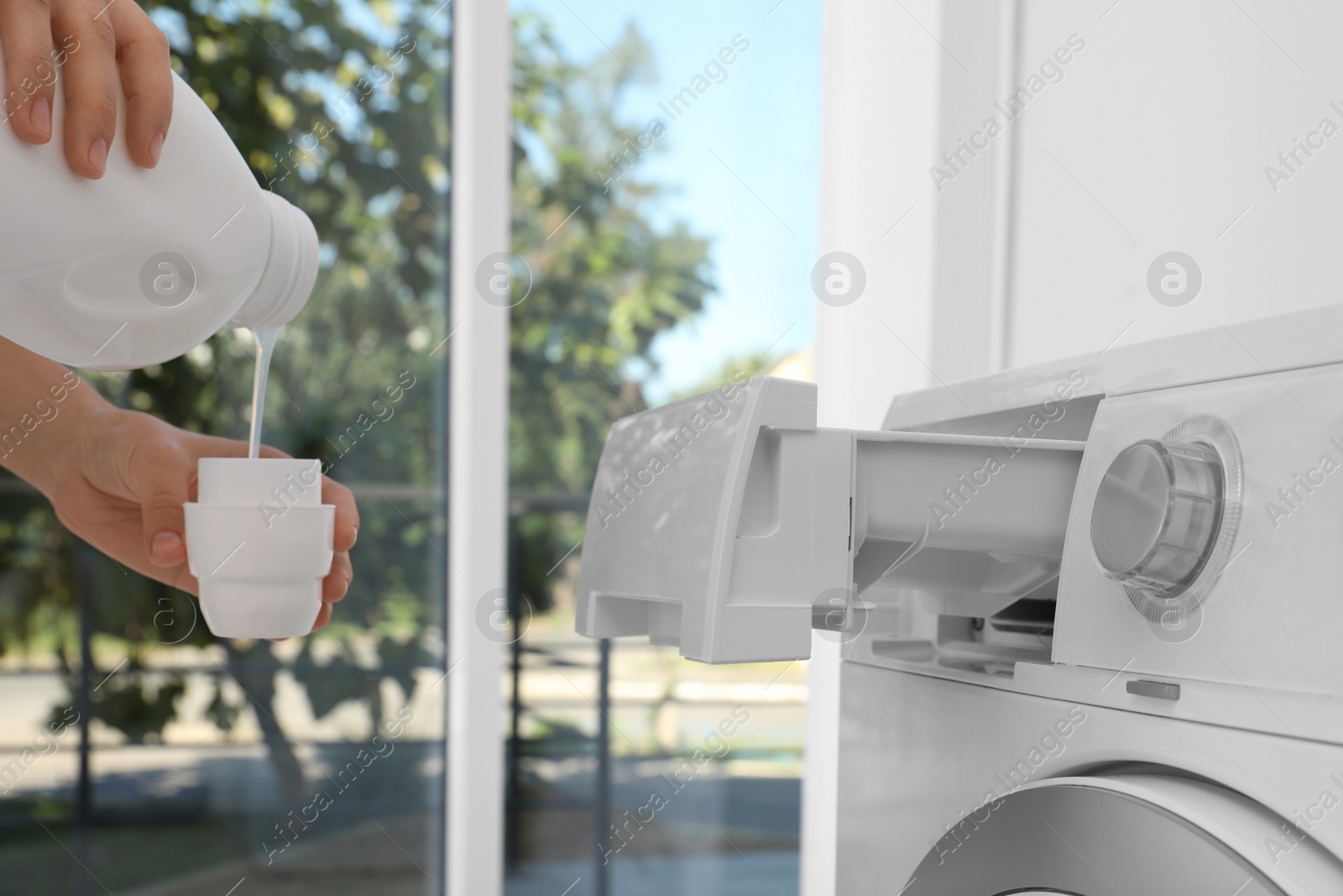 Photo of Woman doing laundry at home, closeup on hands