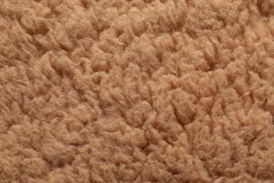 Texture of brown faux fur as background, closeup