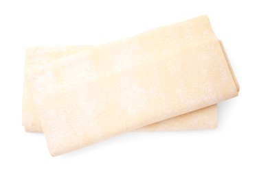 Photo of Raw puff pastry dough isolated on white, top view