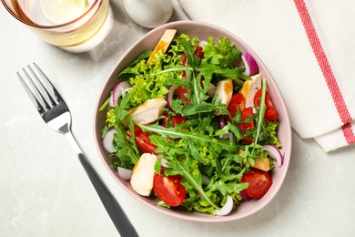 Photo of Delicious salad with chicken, arugula and tomatoes on grey table, flat lay