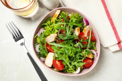 Delicious salad with chicken, arugula and tomatoes on grey table, flat lay