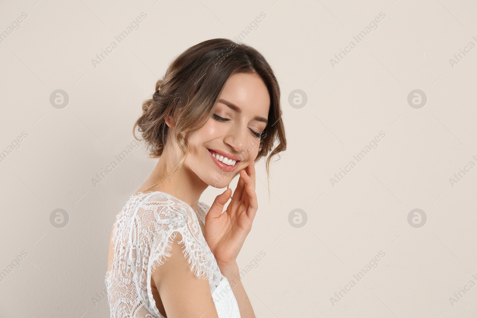 Photo of Young woman with beautiful hairstyle on beige background. Space for text